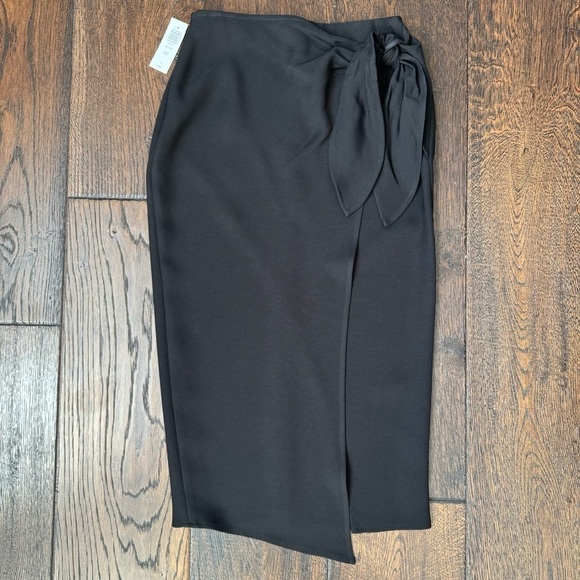 Babaton Dresses & Skirts - Babaton Black Wrap Skirt with Bow Detail